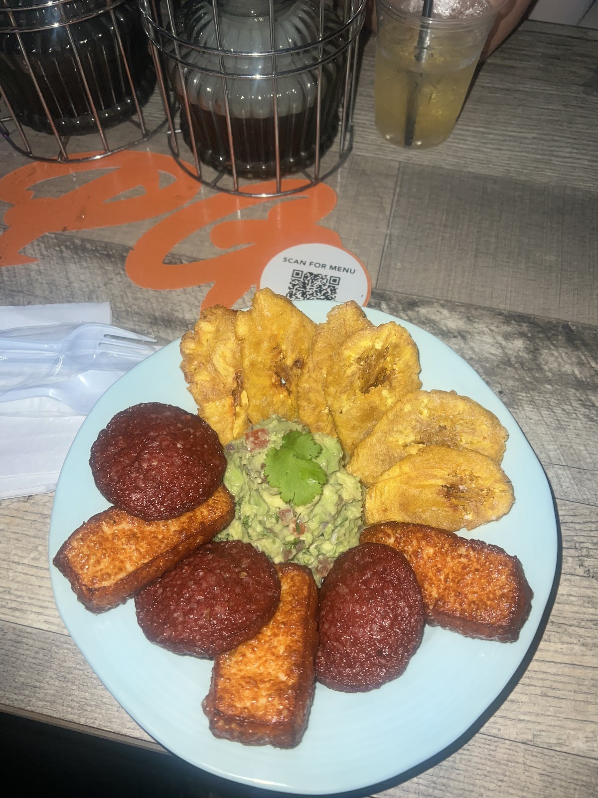 Salami, tostones and guacamole plate with drinks at PreGame Dyckman
